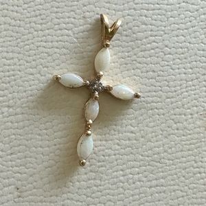 14K gold opal cross with diamond center stone.